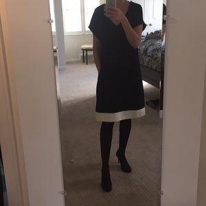 Black "tent" dress with white leather piping.